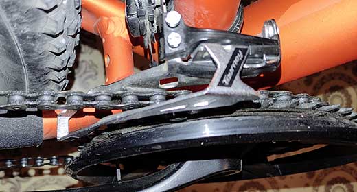 Chain rubbing front derailleur cage high gear, MTB, road bike?